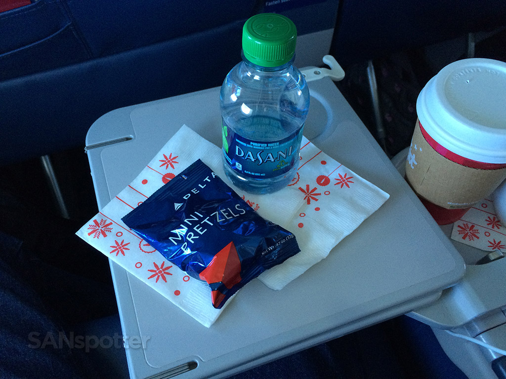 water and pretzel snack in first class