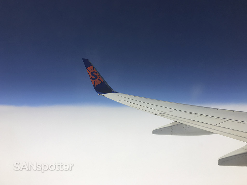 Flying over clouds Sun country winglet 