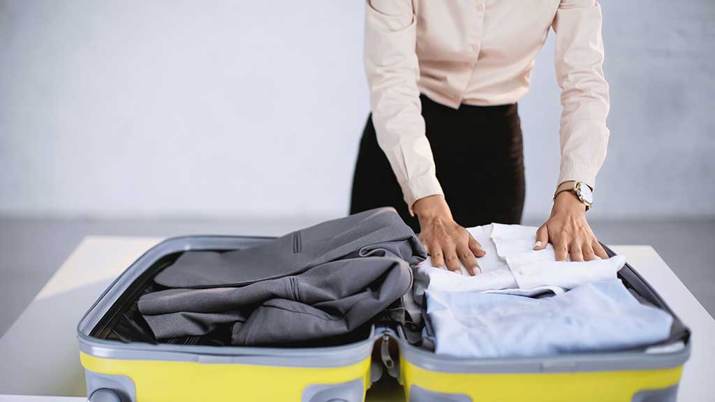 packing a suit in a suitcase