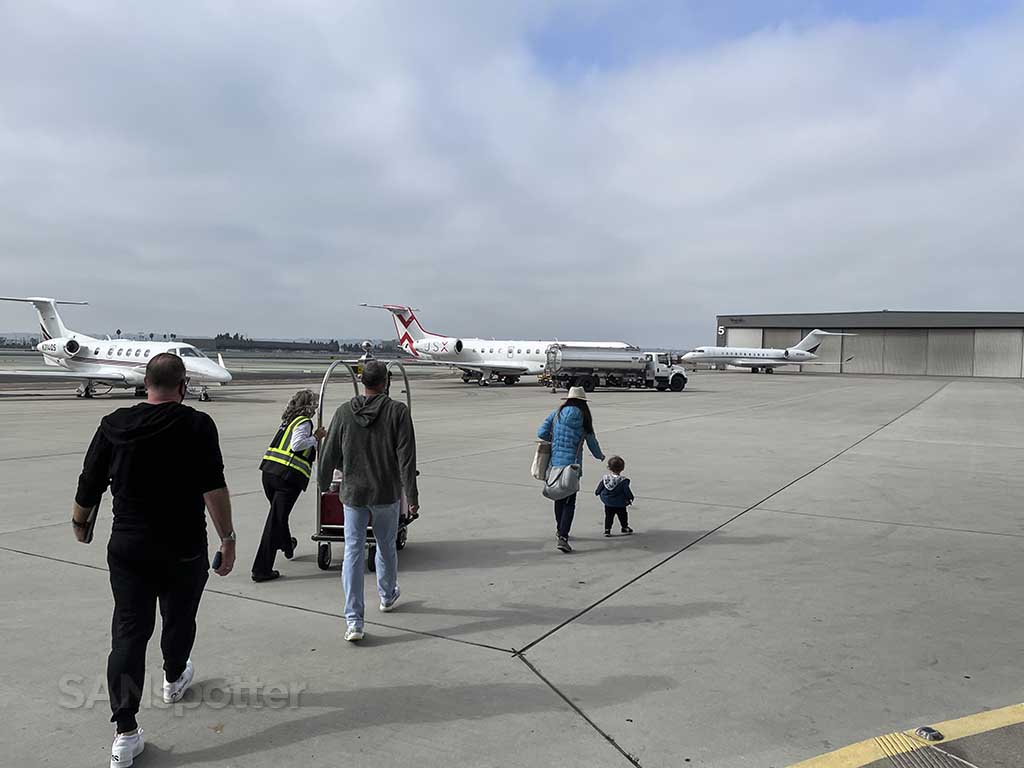 Walking to plane business jet terminal SAN