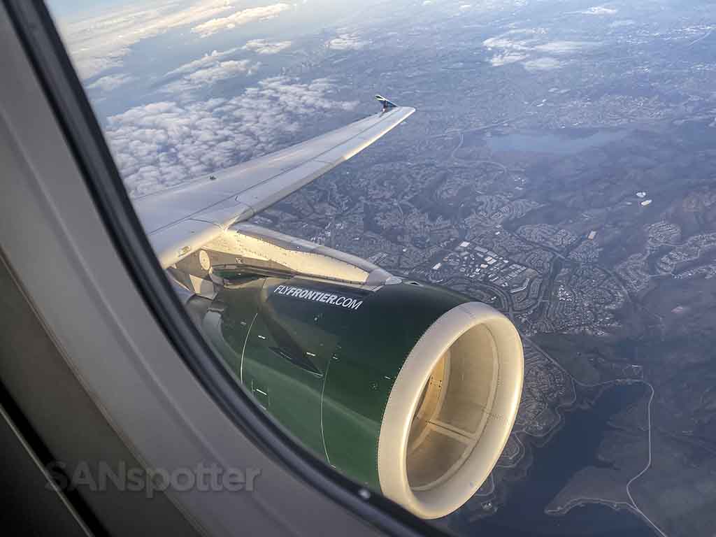view of frontier airlines engine and wing
