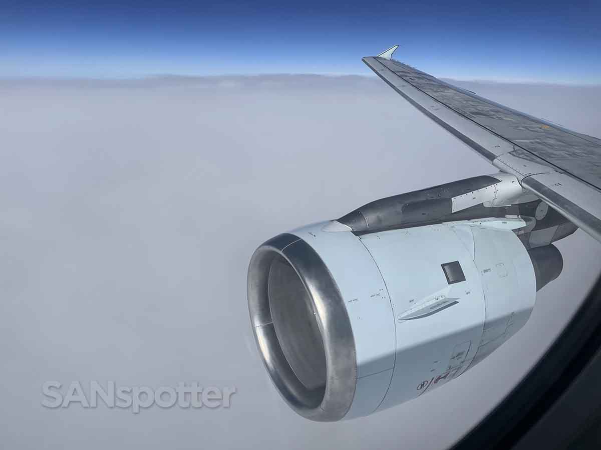 Air Canada a320 engine and wing flying over the clouds