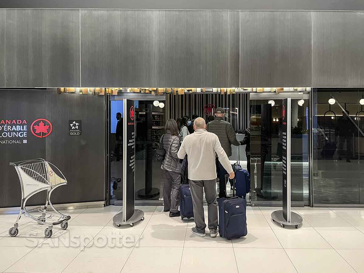 Air Canada Montreal maple leaf lounge line of people