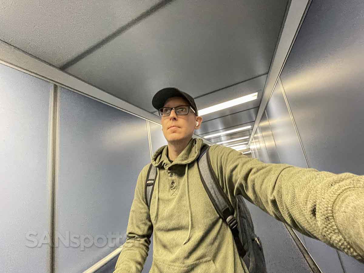 SANspotter walking down jet bridge to board sun country airlines flight
