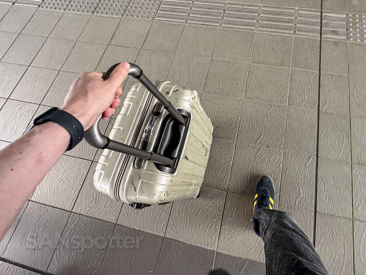 SANspotter walking into Hiroshima airport with suitcase