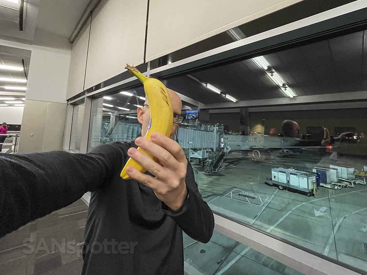 SANspotter holding a banana in terminal 2 west San Diego airport