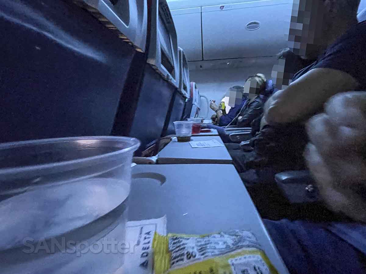 Delta 757-200 Comfort Plus passengers eating snacks