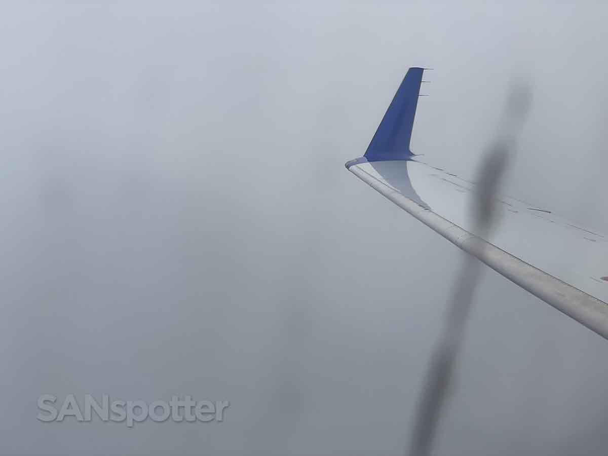 United express CRJ-200 flying through the clouds
