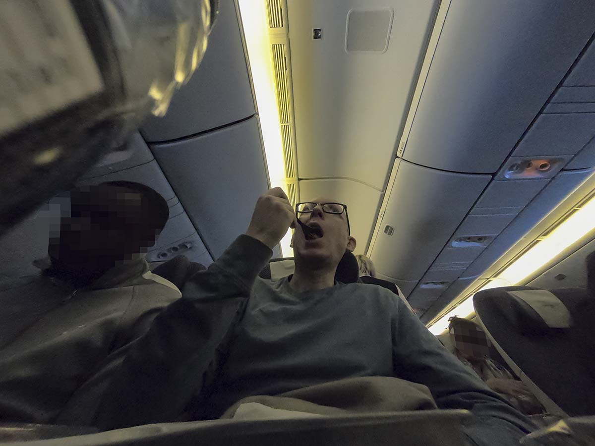 Scott Leazenby eating in British Airways 777-300ER economy