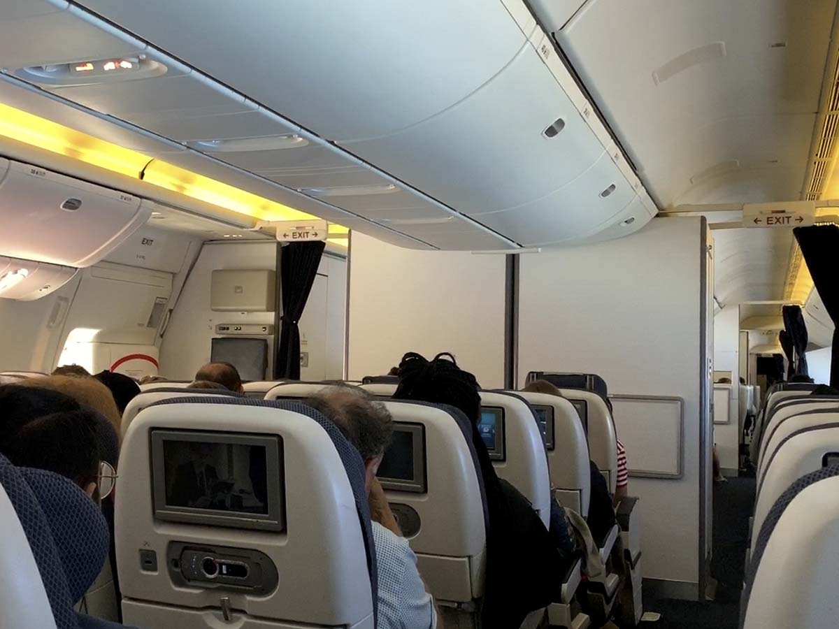British Airways 777-300ER economy cabin during approach to LHR