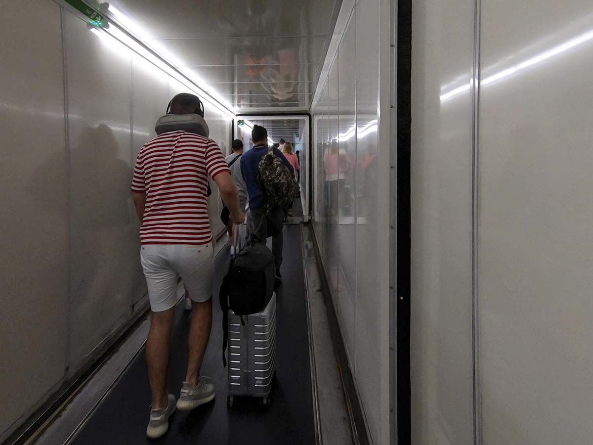 Walking up jet bridge at London Heathrow airport