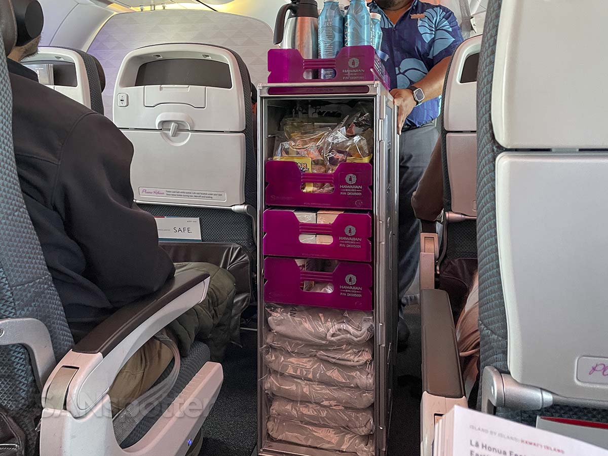 Hawaiian Airlines A321neo snack and beverage cart coming down the aisle