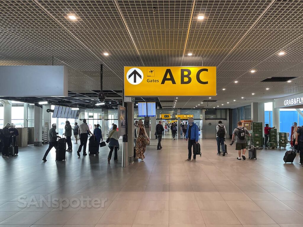 Signs pointing to the A, B, and C gates Amsterdam airport