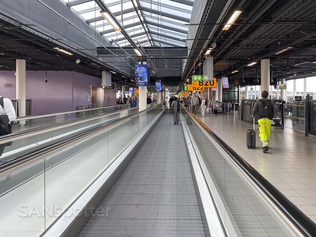 Walking along the moving walkway Concourse B AMS