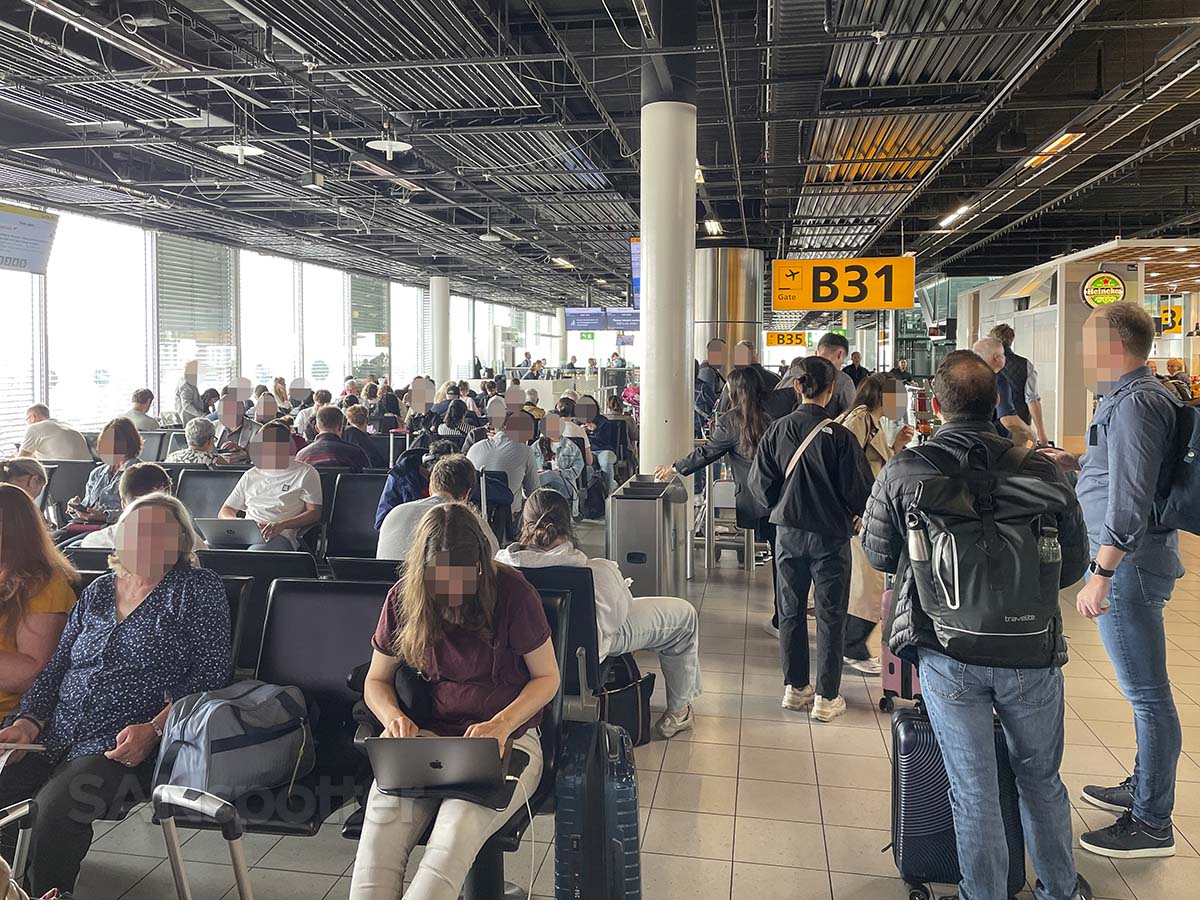 Passengers waiting for a flight at gate B31 Amsterdam airport