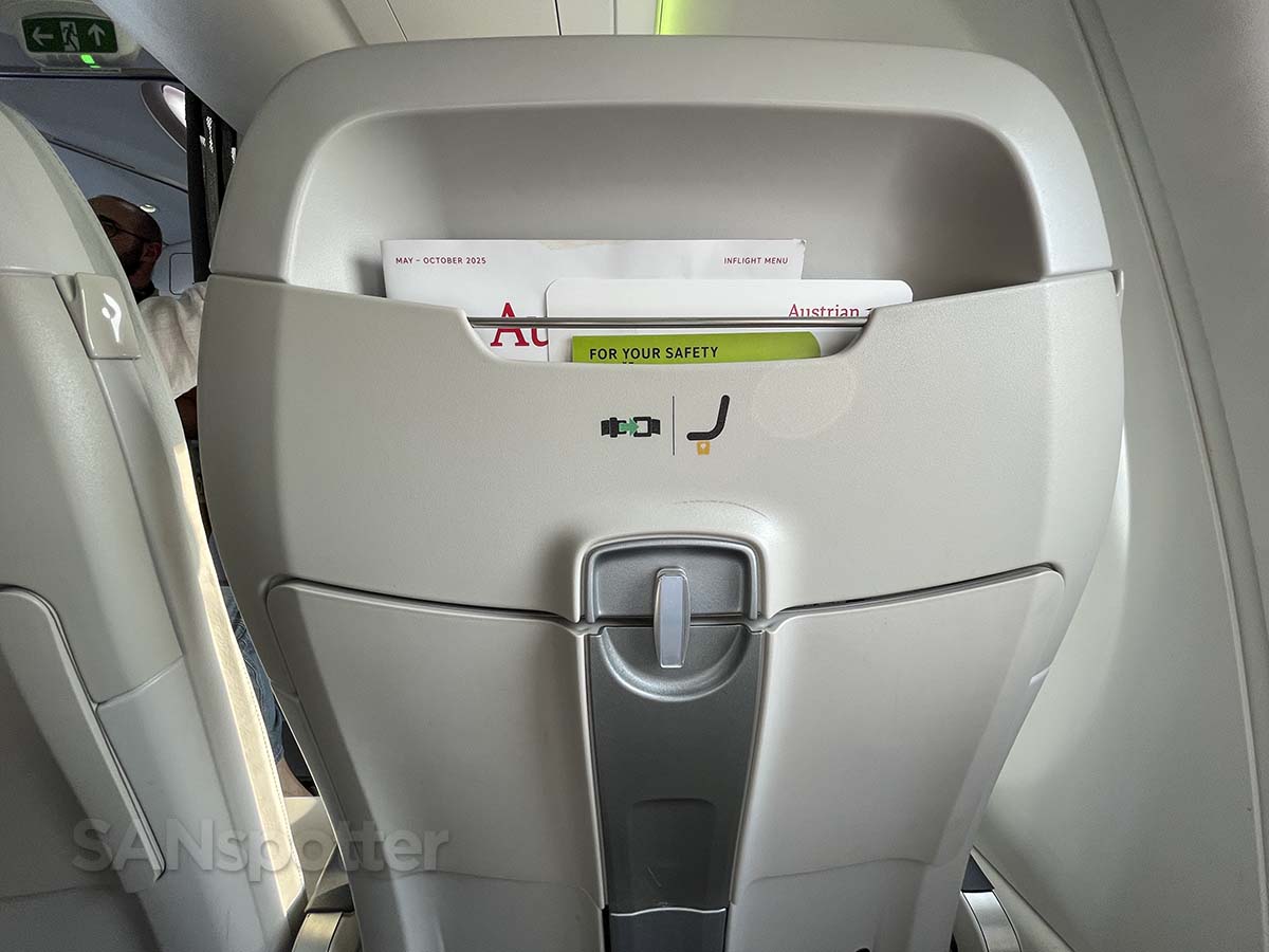 Air Baltic A220-300 business class seat back with storage compartment and tray table