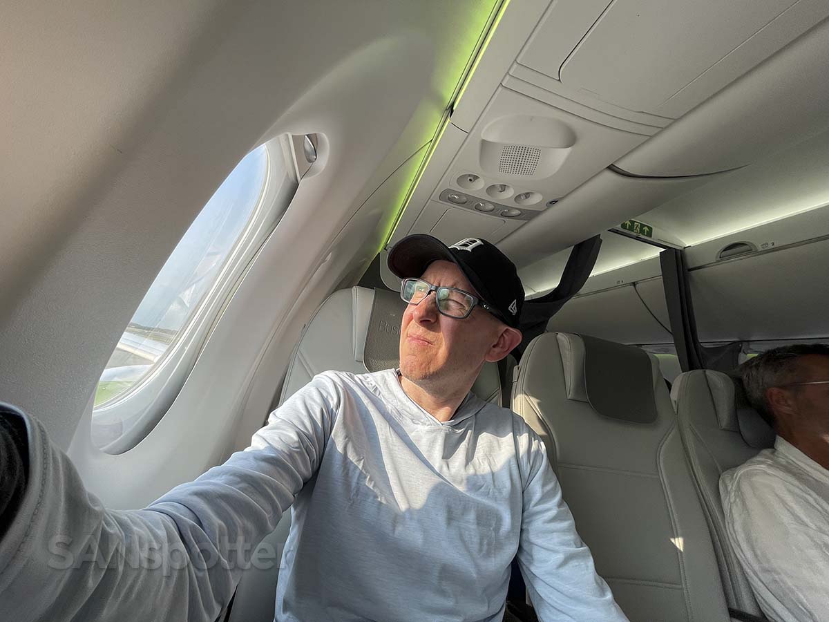 Scott (SANspotter) sitting in Air Baltic A220-300 business class bulkhead seat