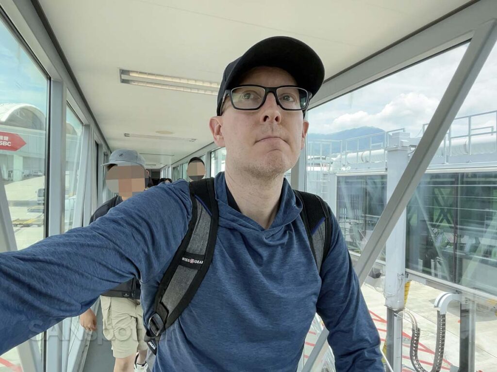 Scott (SANspotter) walking up a glass jet bridge moments after arriving on a flight at the Hong Kong international airport