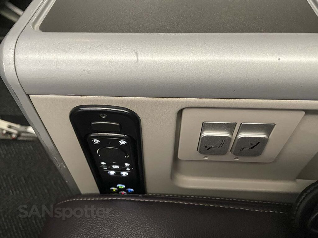 United Airlines 777-300ER Premium Plus seat controls and remote control for video entertainment located in the center armrest