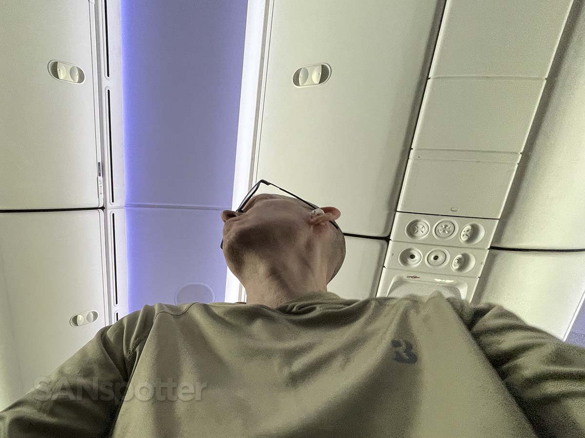 Scott (SANspotter) trying to look out the window from the middle section of United Airlines 787-9 premium plus