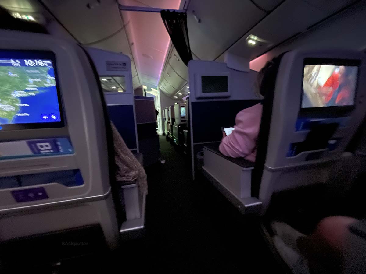 Looking up the aisle towards business class from the premium plus cabin on a United Airlines 787-9