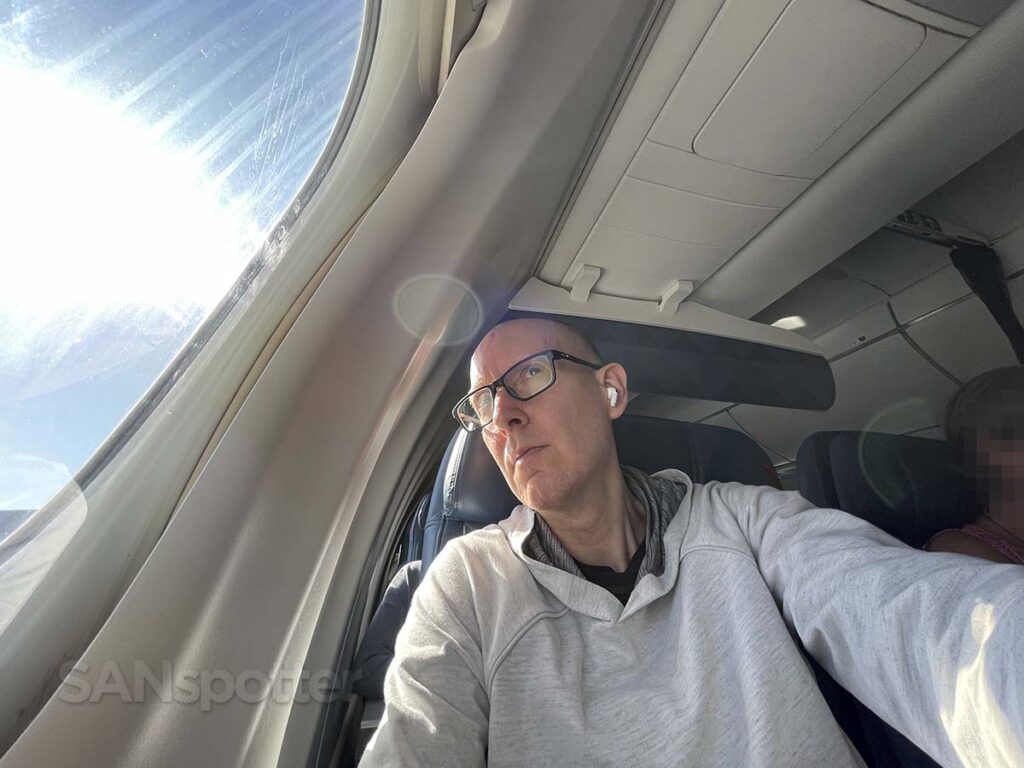 SANspotter looking out the window of a Delta A220-100 