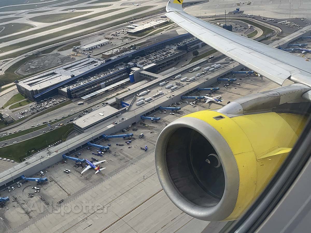 Spirit Airlines A320 taking off from runway 04R at DTW with a view of the Evans terminal below