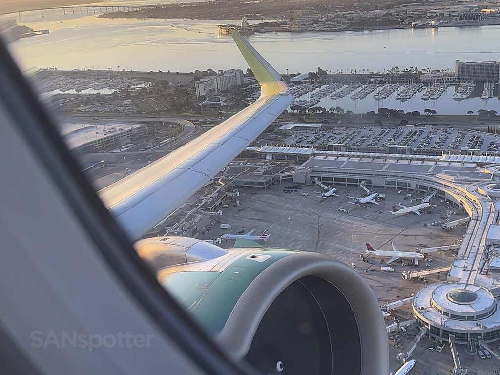 Frontier Airlines A320neo taking off from runway 27 at SAN with terminal 2 in the background