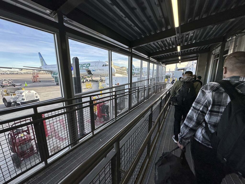 Passengers walking outside to board frontier airlines aircraft gate A79 Denver International Airport