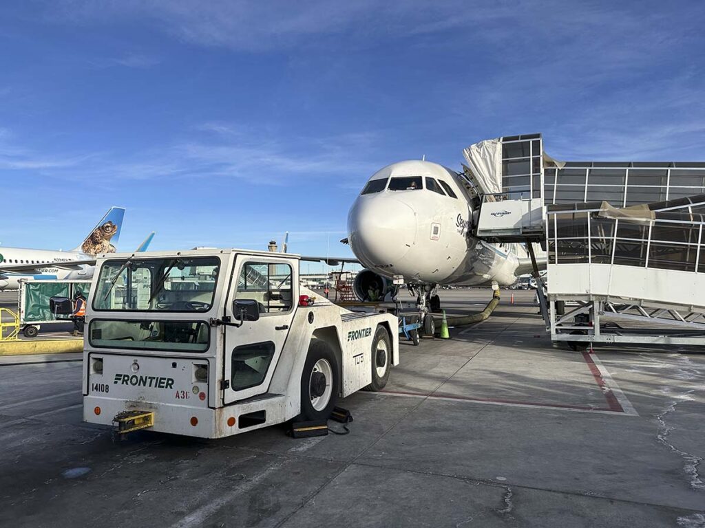 Frontier Airlines A321 and tug at the Denver International Airport