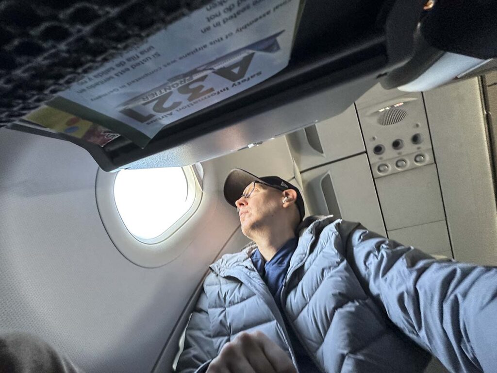 Scott Leazenby looking out the window from the seat 2F in Frontier Airlines A321 UpFront Plus