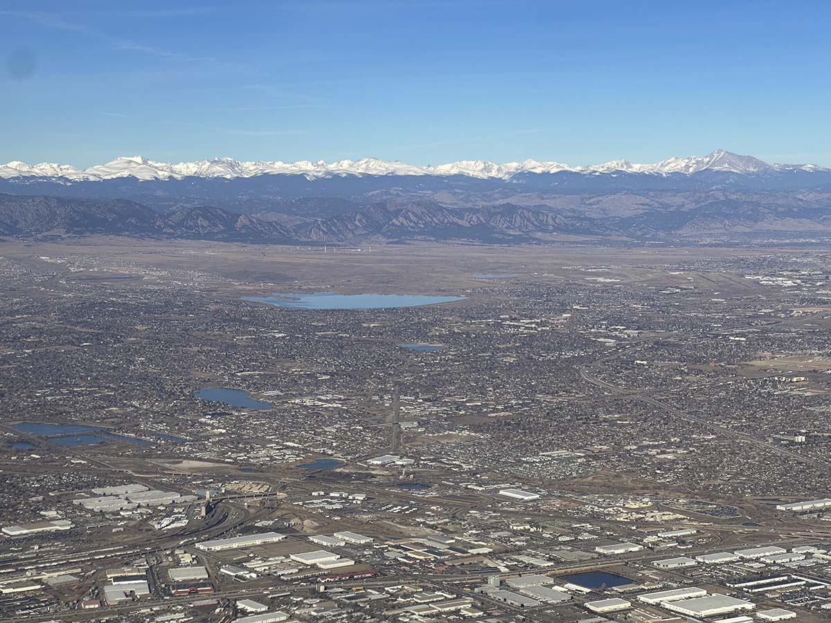 Flying west towards the Rocky Mountains just moments after taking off from runway 25 Denver International Airport