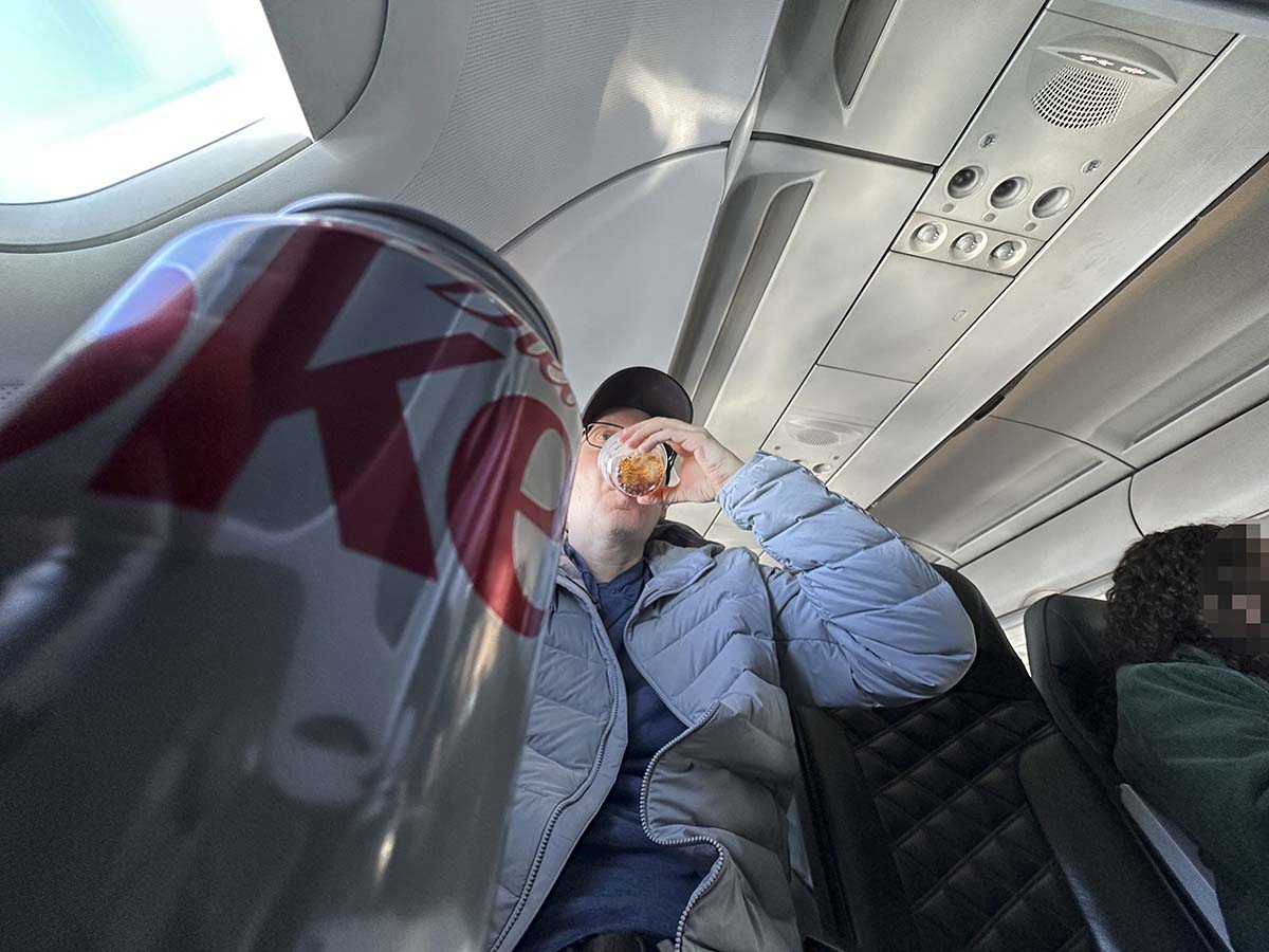 Scott Leazenby drinking Diet Coke in Frontier Airlines A321 UpFront Plus