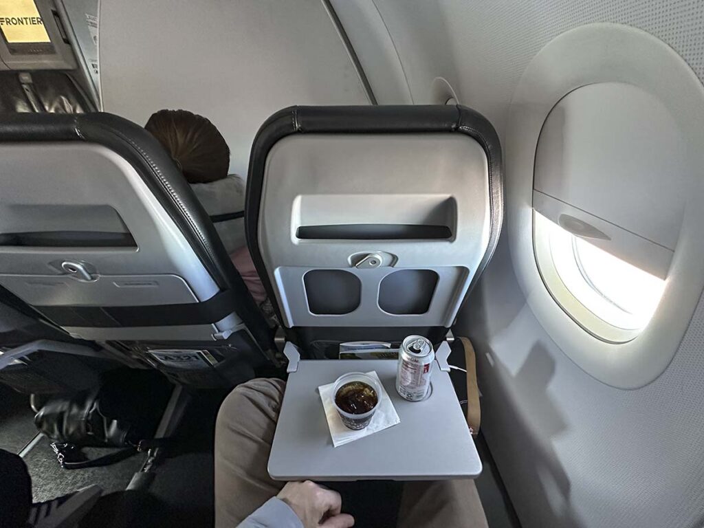 Enjoying a drink in Frontier Airlines A321 UpFront Plus
