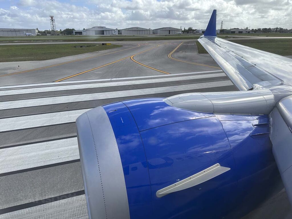 Looking out the window from seat 10F in a United 737 MAX 9 while rolling down the runway for takeoff at PBI