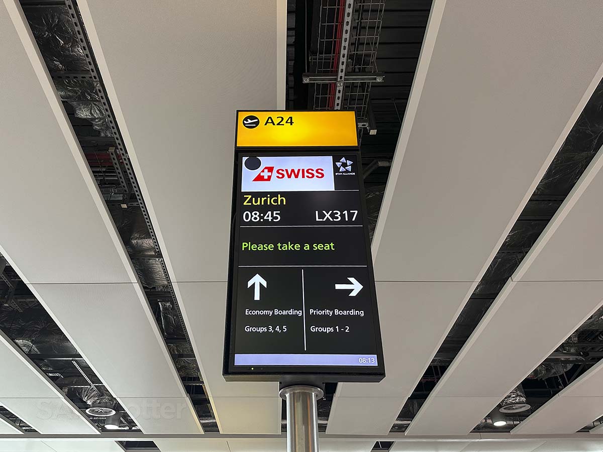 Swiss Airlines gate A24 information display in terminal 2 at LHR showing economy boarding and priority boarding queues