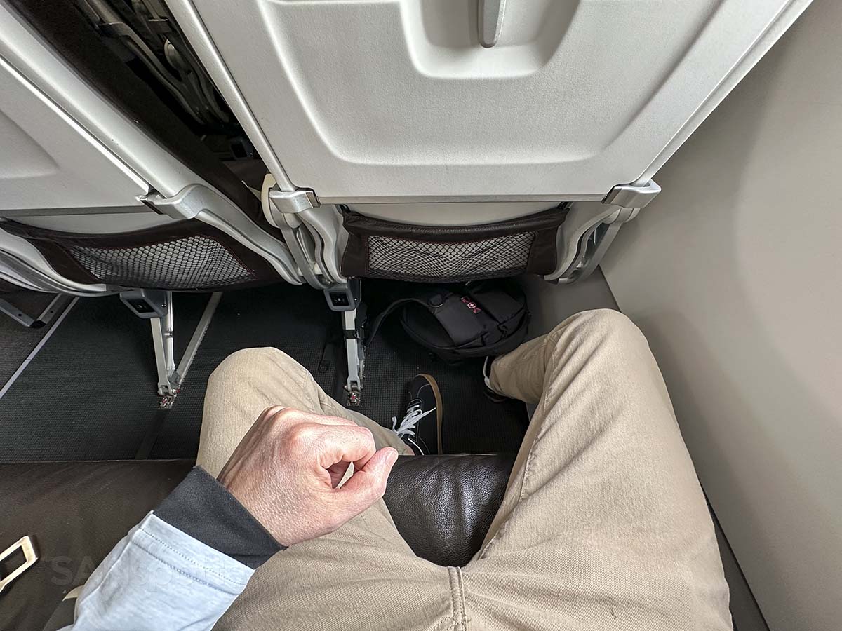Swiss A320neo business class under seat storage space with black carpet
