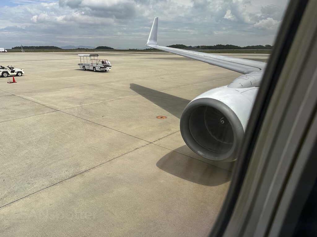 Japan Airlines 737-800 pushing back from the gate at the Hiroshima Airport