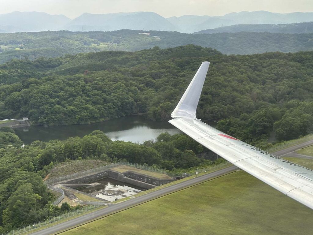 Japan Airlines 737-800 wing and winglet just moments after taking off from runway 10 Hiroshima Airport