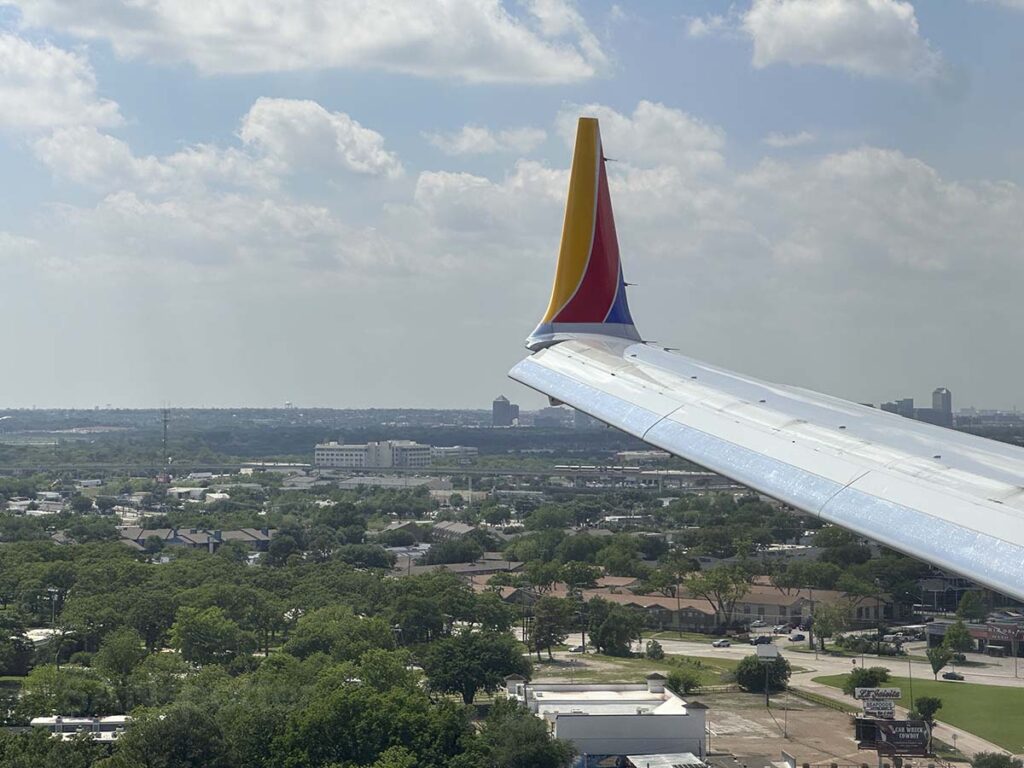 Southwest Airlines 737 MAX 8 wing and winglet on short final for a runway 13R at DAL