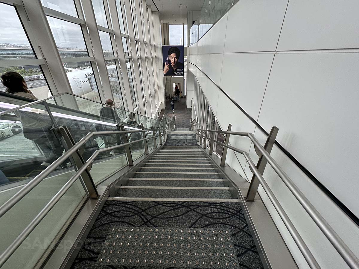 Walking down the stairs leading to the jet bridge Gate 114 terminal 3 Tokyo Haneda airport