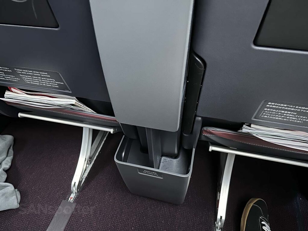 Storage bin located down beneath and between the seats in JAL A350-1000 premium economy