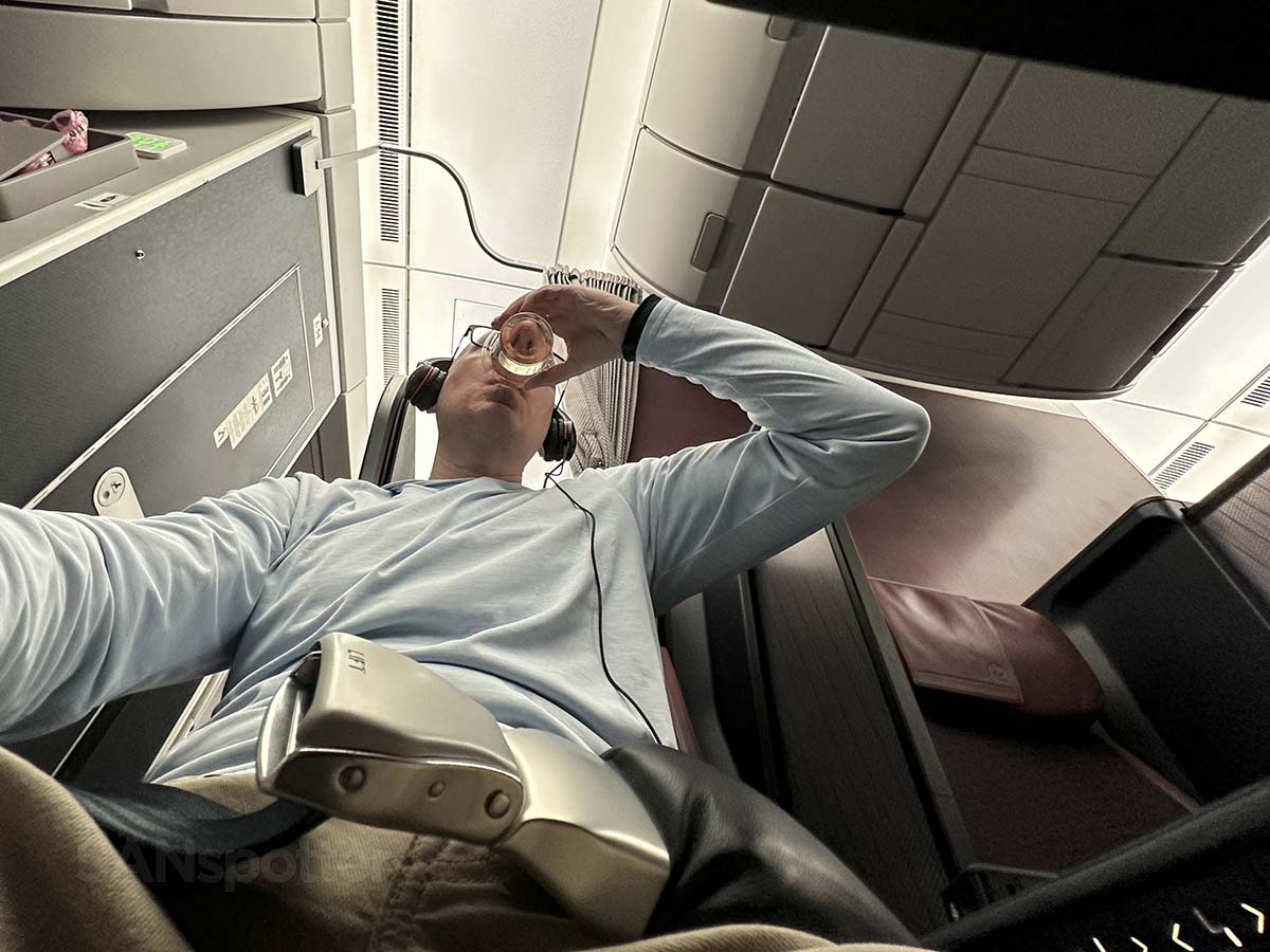 Scott Leazenby drinking wine in JAL A350-1000 Premium Economy