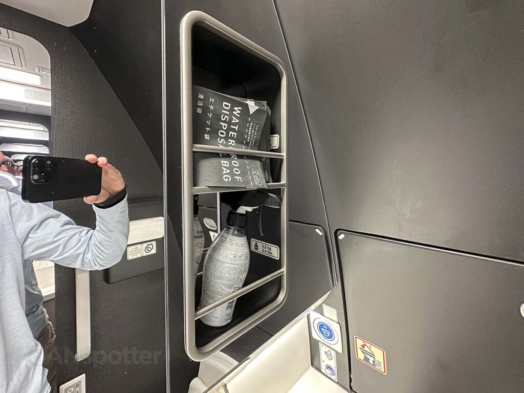 Storage shelf with air freshener in the JAL A350-1000 Premium Economy lavatory