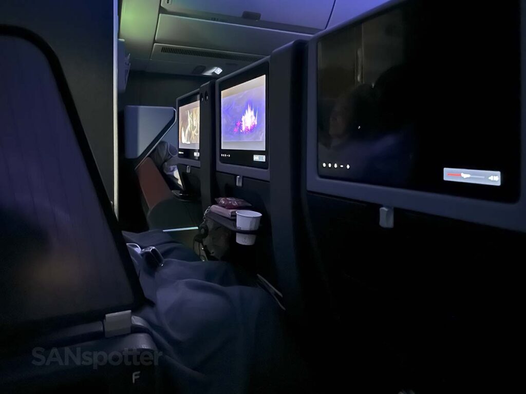 Light from the video screens in the dark cabin in JAL A350-1000 Premium Economy