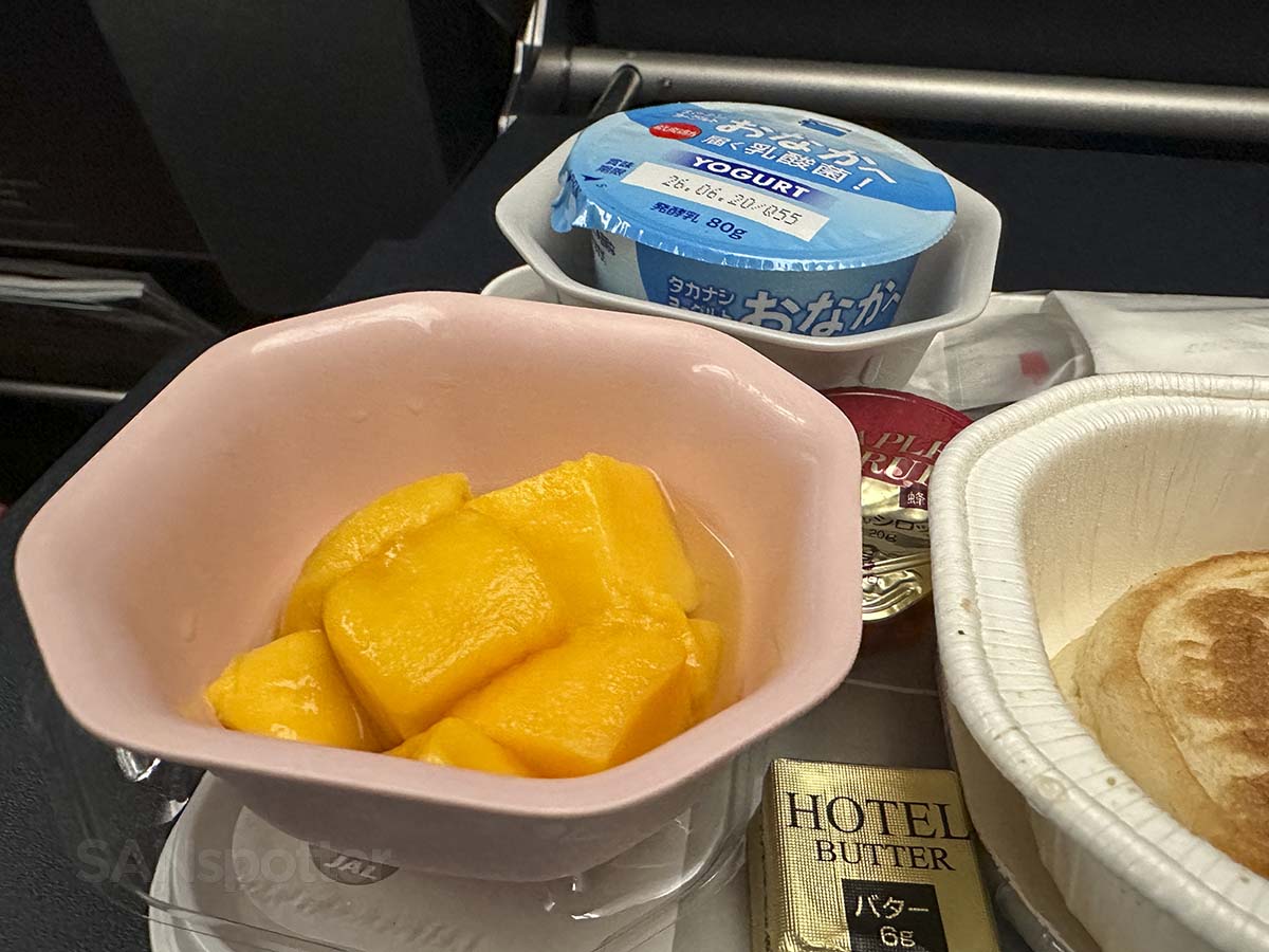 Peaches and yogurt side dishes served with breakfast in JAL A350-1000 Premium Economy