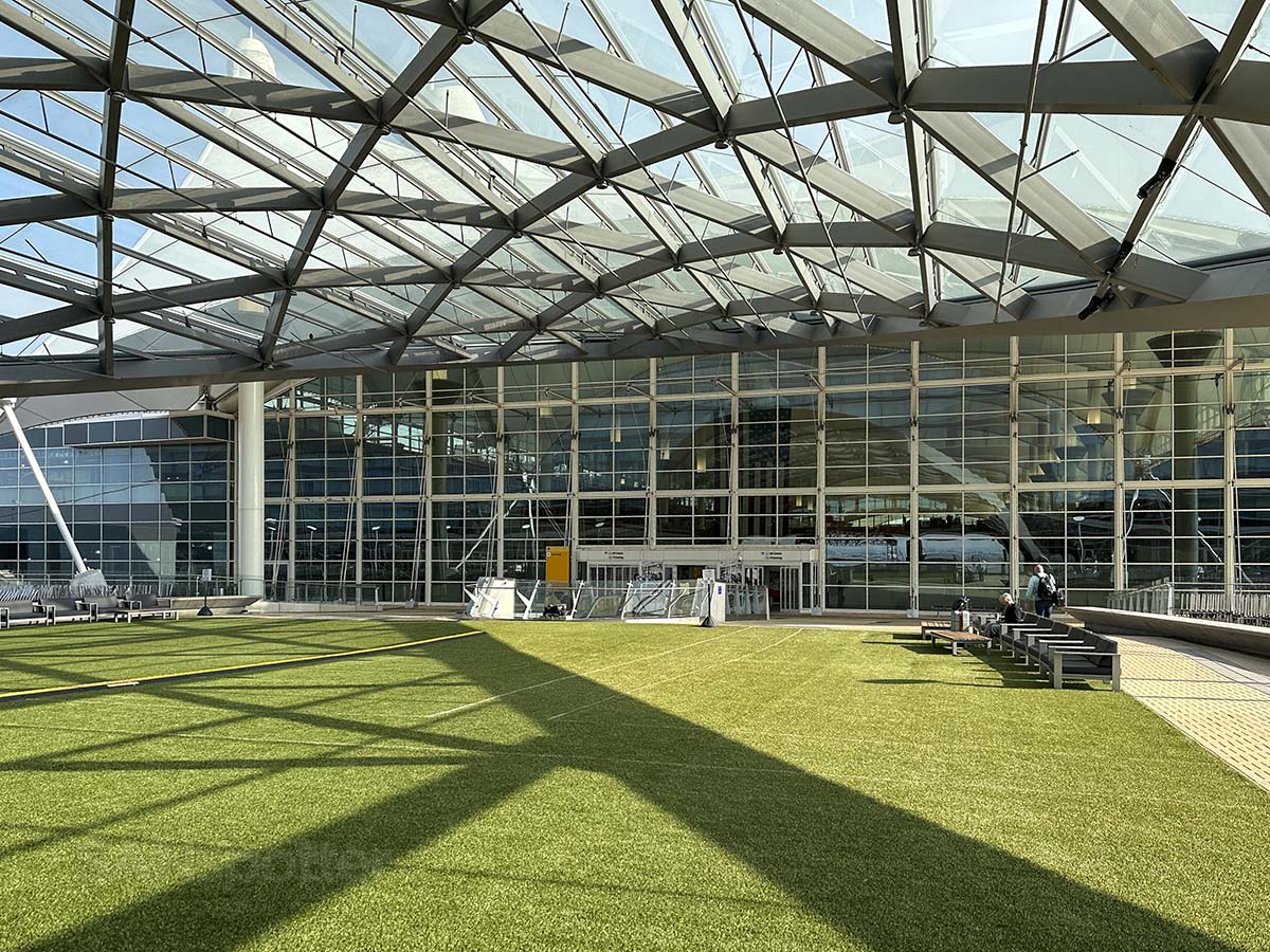 Standing outside of the main terminal of the Denver International Airport in the grass covered Plaza next to the Westin hotel