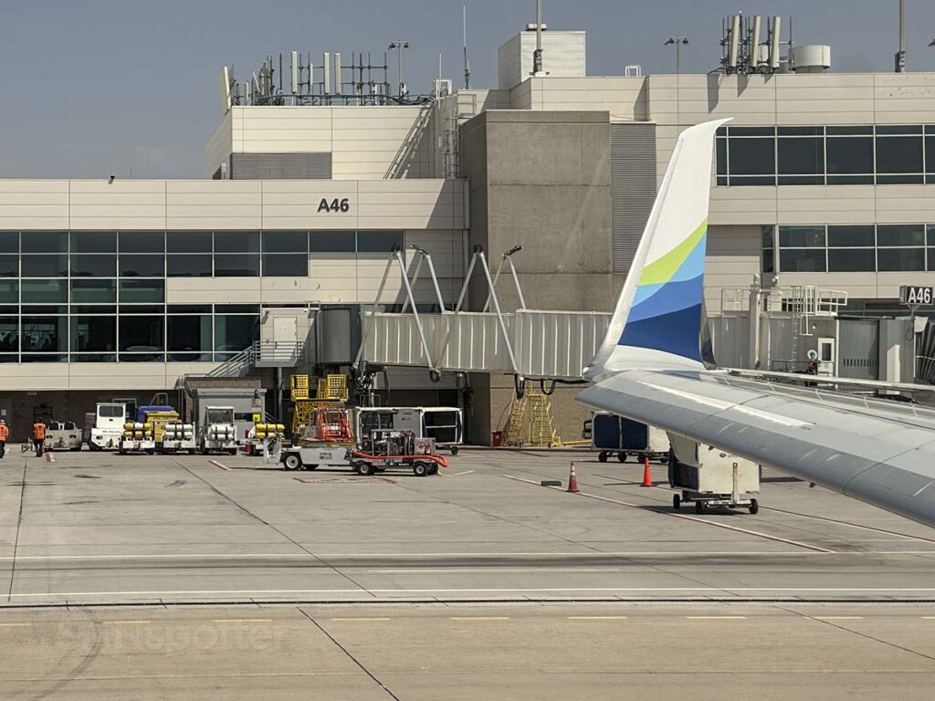 Alaska Airlines 737-800 wing and winglet passing by Concourse A Denver International Airport