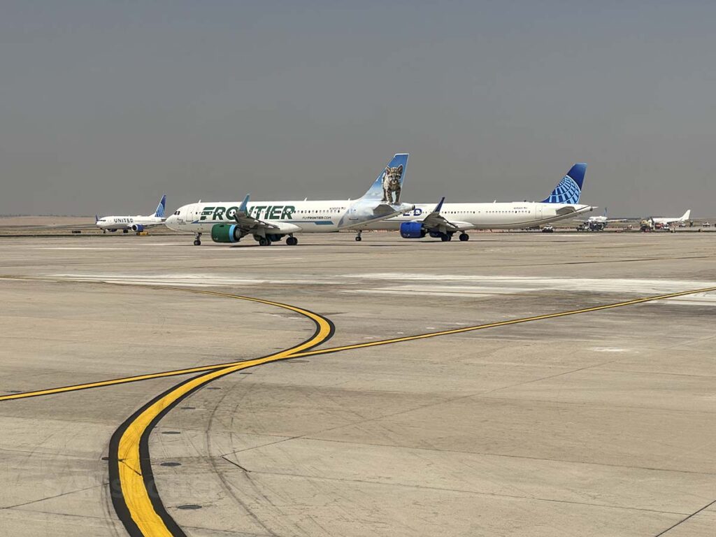 United Airlines and Frontier Airlines aircraft taxiing out for departure Denver International Airport