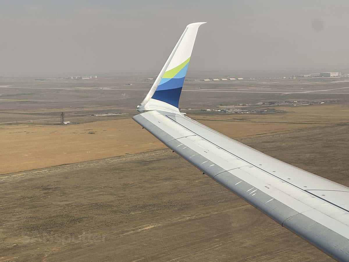 View of Alaska Airlines 737-800 wing and winglet just moments after taking off from runway 25 at DEN